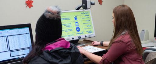 Students using computer technology inside the Disability Resource Center.